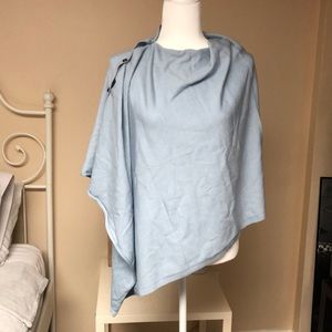 Light blue poncho with tortoise buttons